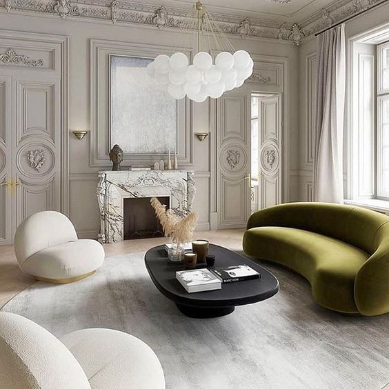 intérieur forme organique canapé design arrondi vert fauteuils arrondis design blanc table basse ovale noire